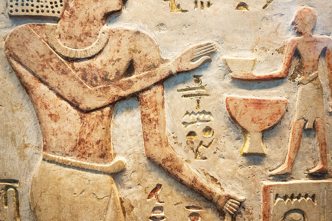 A stone mural, depicting various hieroglyphic carvings