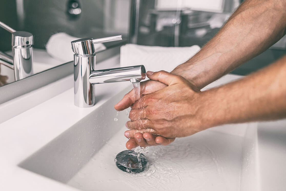 A close-up of a man washing his hands