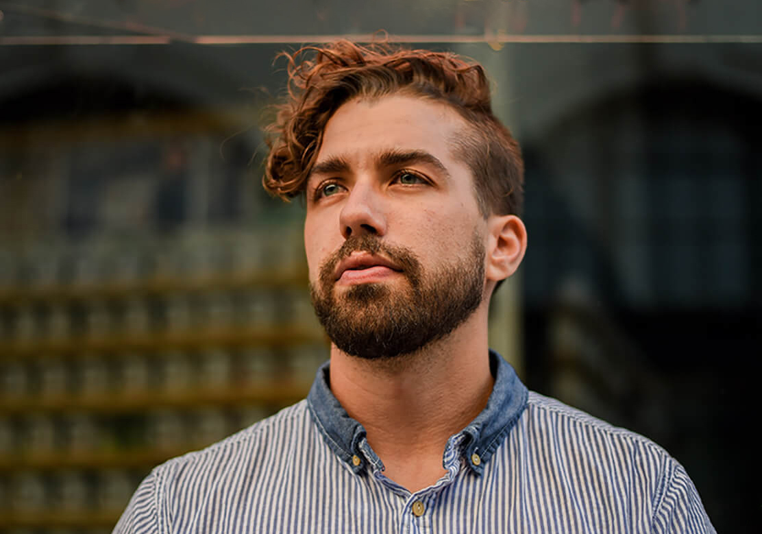 close-up of a man with an undercut and side-swept fringe